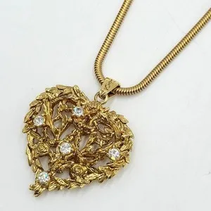 Authentic The Golden Heart of Saint Laurent: A Vintage Talisman of Devotion