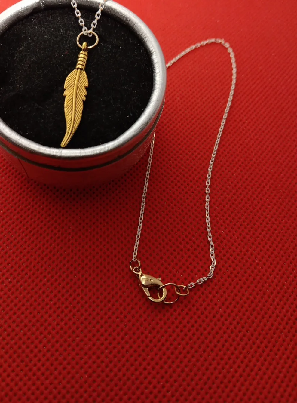 Authentic Jewelry Sequin 16" Necklace With Gold Plated Feather pendant.