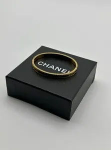 Authentic The Golden Cipher of the Maison: Engraved Chanel Bangle