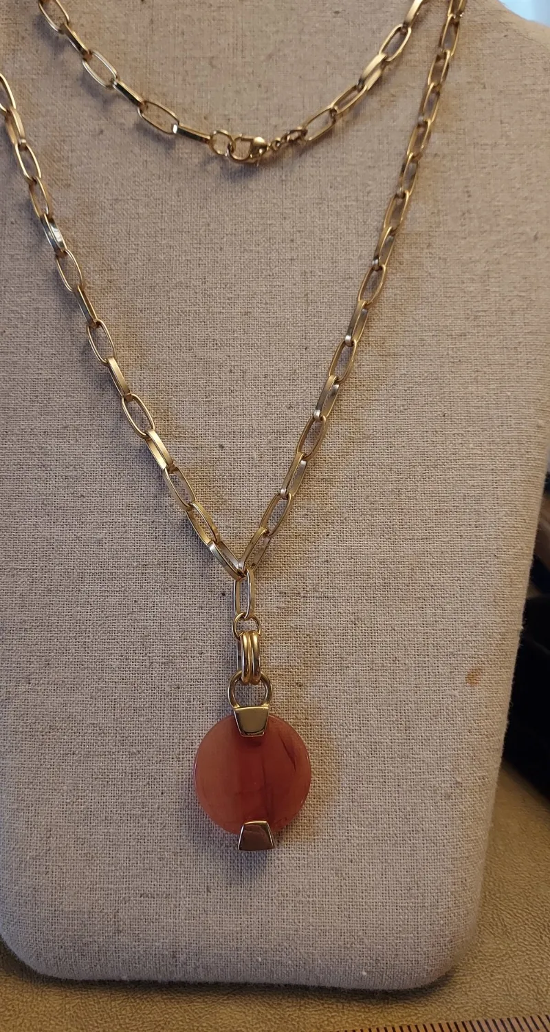 Authentic gold plated oval chain 34" long with round amber colored plastic pendant on end