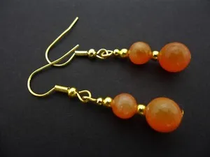 Authentic A PAIR OF ORANGE JADE GOLD PLATED DANGLY EARRINGS. .