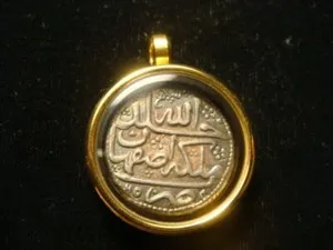 Authentic MUSLIM silver coin 18th Century in glass and Gold plated bezel.