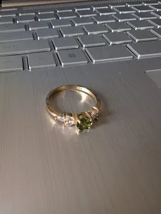 Authentic size 10 gold plated ring, faux peridot center stone with faux marquis cudiamonds