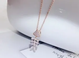 Authentic Celestial Swirl Fishbone Talisman – Gold‑Plated Cubic Zirconia Pendant