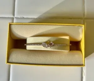 Authentic Swarovski Mesmera Bangle rose gold plated finish. Pear and octagon crystals NWOT