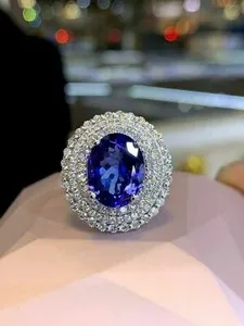 Authentic Celestial Harmony: 4Ct Oval Cut Simulated Blue Tanzanite Halo Engagement Ring