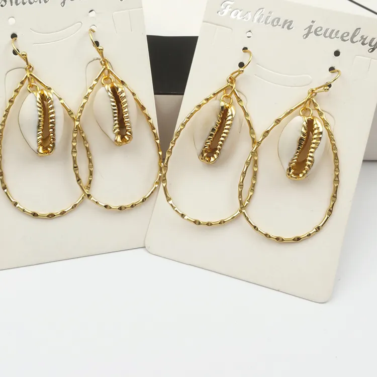 Authentic Coastal Resonance: The Gilded Cowrie Tear Drop Hoops
