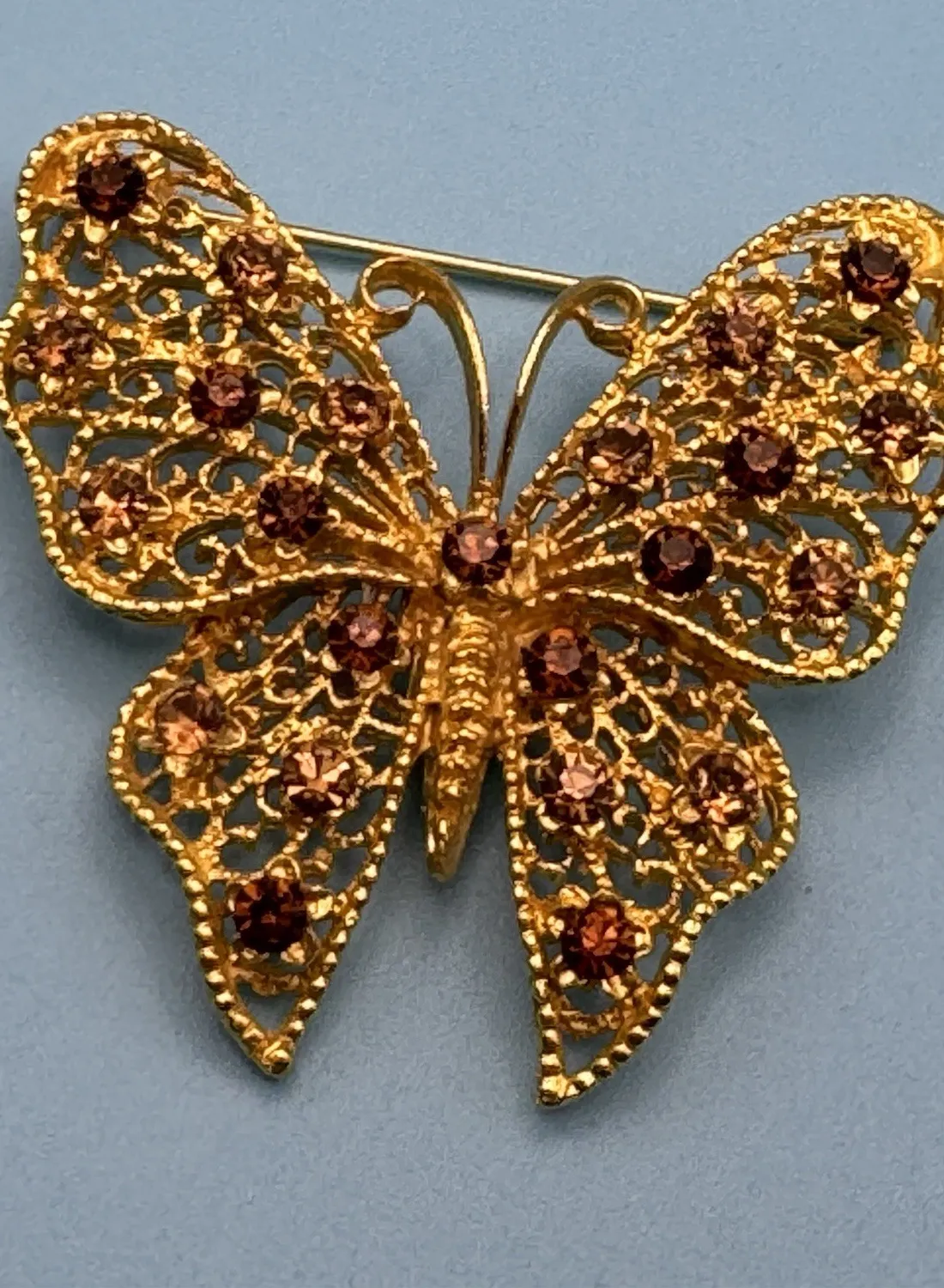 Authentic  Butterfly brooch filigree gold-plated metal base. Amber colored rhinestones 
