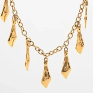 Authentic Celestial Tie‑Knot Amulet – Gold‑Plated Chanel Coco Emblem