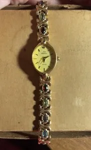 Authentic Celestial Timekeeper: Gold‑Plated Watch Cradling Peridot & Amethyst